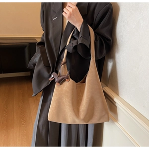 Detail of light brown matte tote bag with cute dachshund puppy pendant and wide strap