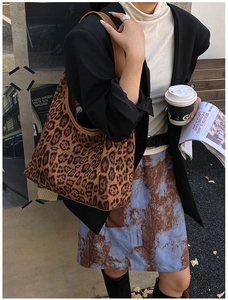 Street style view of leopard print shoulder bag worn with casual blazer and skirt