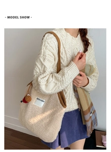 Model wearing a fuzzy beige plush tote bag with a SEEYOU leather patch and brown strap