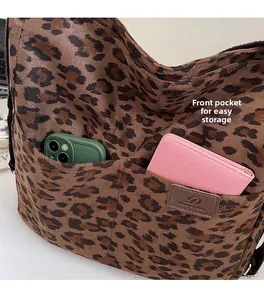 Detail of leopard print tote bag showing front pockets for easy storage of small items