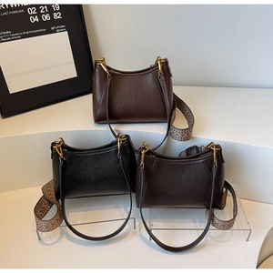 Close-up of three vintage hobo bags showing lychee grain leather and dual straps