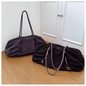 Vue détaillée de grands sacs cabas plissés en noir et violet avec anses en corde