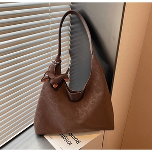 Close-up of dark brown tote bag with vintage texture and cute dachshund charm