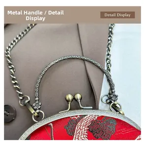 Detailed view of red silk embroidery bag with bronze metallic handle and clasp
