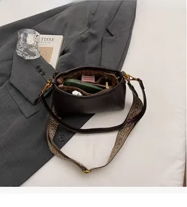 Detail view of large capacity dark brown bucket bag with multi-compartment storage