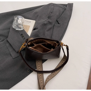 Detail view of large dark brown leather hobo bag with dual straps and organized interior