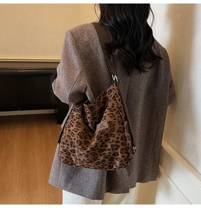 Detailed back view of a woman wearing the large capacity leopard print canvas tote bag