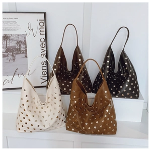 Detail view of four leather hobo bags in various colors featuring metal rivet studs