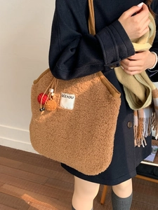 Chic coffee brown faux shearling tote bag with SEEYOU label and colorful pom-poms