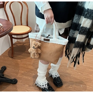 Brown suede tote bag with white faux fur trim and cute teddy bear charm detail