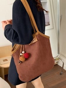 Fashionable caramel brown suede underarm tote bag with plush charms and shoulder strap