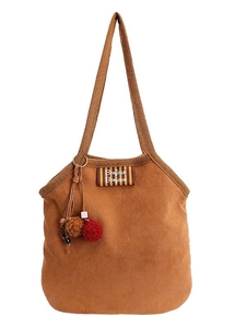 Brown suede underarm tote bag with Bonjour label and colorful charm in white background