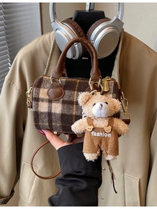 Minimalist plaid cylinder handbag with brown leather strap and bear charm accessory