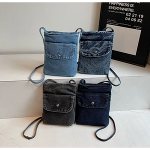 Detailed display of four mini denim crossbody bags in light blue, grey and dark blue washes