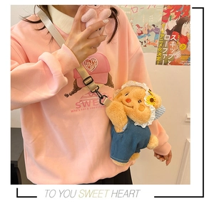 Close-up of cute plush bear crossbody bag with denim overalls and lace hat on model