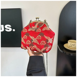 Detail of red brocade purse with gold crane embroidery and vintage metal clasp