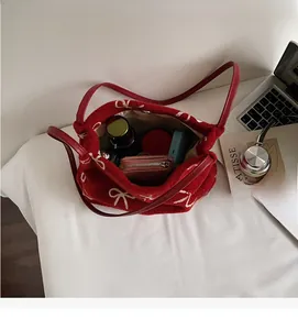 Intérieur spacieux du cabas en velours rouge montrant le rangement du maquillage
