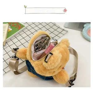 Detailed view of the ginger plush bear bag interior showing phone and lipstick storage
