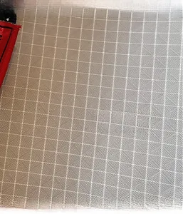 Detailed macro view of gray ripstop canvas fabric with durable grid texture and red trim