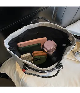 Interior view of checkered tote bag showing spacious storage for tablet and water bottle