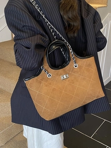 Retro brown suede tote bag with diamond stitching and silver chain strap on model