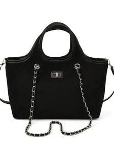 Classic black quilted velvet handbag with silver metal clasp and chain strap on white background