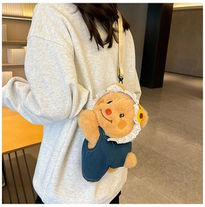 Detail of cute plush bear backpack featuring denim overalls and a yellow lace cap
