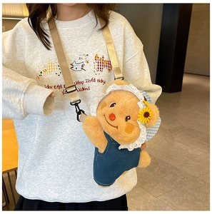 Close-up of cute plush bear bag with denim overalls and yellow sunflower detail