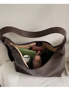 Top view of spacious coffee brown hobo bag showing interior items and large capacity