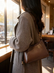 Classic dark brown leather hobo bag for women with trapezoid design and shoulder strap