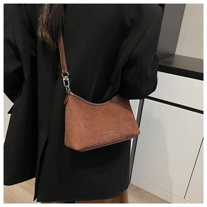 Braune Wildleder Hobo-Tasche am Model getragen, zeigt die große Kapazität und moderne Passform