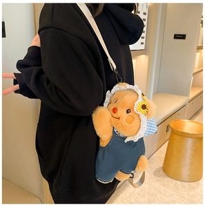 Detail of cute brown teddy bear plush backpack with lace hat and denim overalls