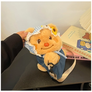 Close-up of cute plush bear bag with blue denim overalls and sunflower hat detail