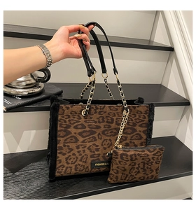 Detail of leopard print tote bag with plush trim, gold chain, and matching coin purse