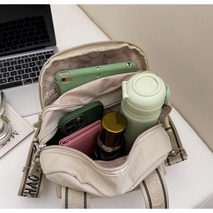 Vue intérieure du sac en toile beige montrant plusieurs compartiments et une grande capacité