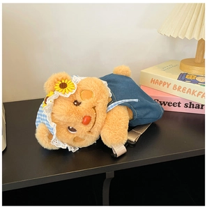 Detailed view of the plush bear bag with denim dress and adjustable nylon straps