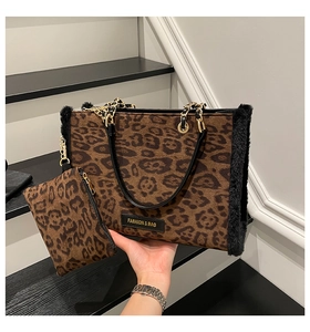Detail of leopard print tote bag with faux fur trim, gold chain strap and matching pouch