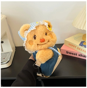 Detail of yellow plush bear crossbody bag with denim outfit and adjustable strap