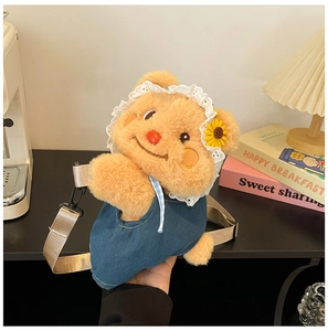 Detail of cute brown plush bear bag with lace headscarf and sunflower decoration
