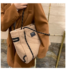 Détail du cabas en polaire beige avec poignées en corde tressée noire et étiquette