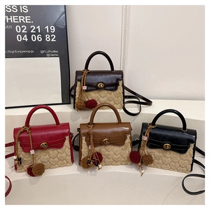 Detail view of plush faux fur Kelly bags with heart textures and fluffy charms in four colors