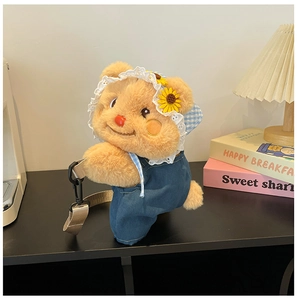Detail of cute teddy bear plush bag with denim overalls and floral plaid hat