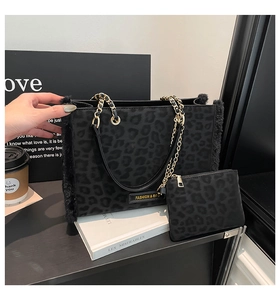 Detail of leopard print tote bag set with metal chain strap and plush fur trim accents