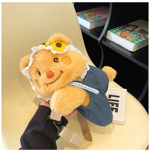 Detail of plush bear backpack with sunflower hat, lace trim, and denim overalls style