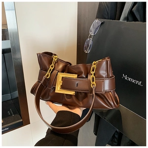 Detail of a dark brown pleated leather shoulder bag with gold square buckle and chain strap