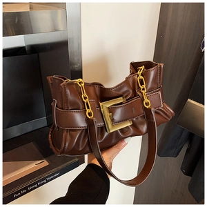 Detail of a brown ruched shoulder bag with a gold square buckle and metal chain strap