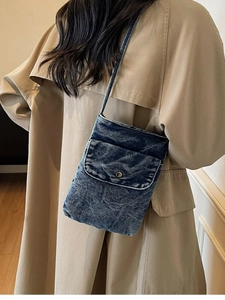 Minimalist dark blue denim crossbody phone bag with front flap and shoulder strap