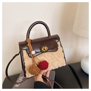 Detail of faux leather and plush faux fur splicing with embossed heart pattern handbag