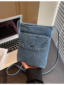 Minimalist blue denim crossbody phone bag with front flap pocket and round strap