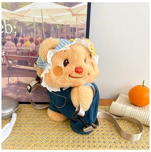 Detail of cute teddy bear plush backpack in denim overalls on a woven tray